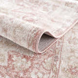 Close-up of the Kandos Blush & Light Pink Area Rug showing its plush texture and oriental-inspired pattern. Fold