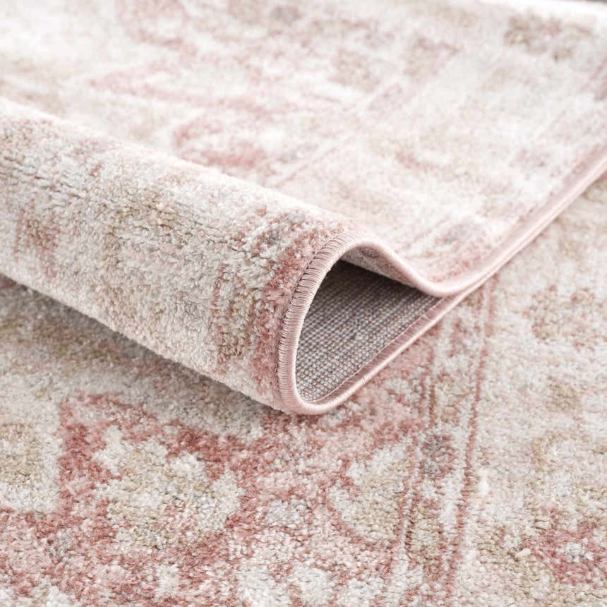 Close-up of the Kandos Blush & Light Pink Area Rug showing its plush texture and oriental-inspired pattern. Fold