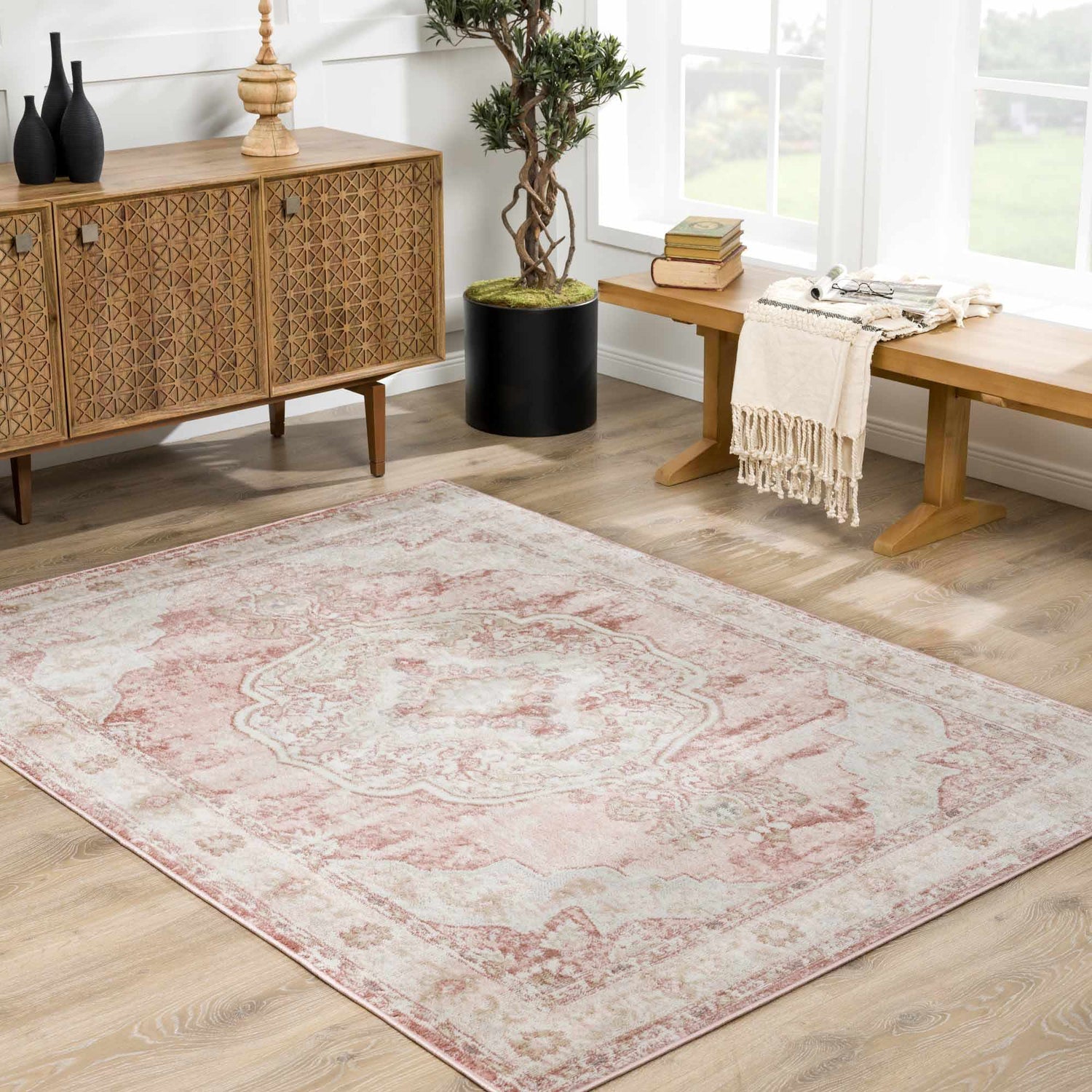 Living room scene with a Kandos Blush & Light Pink Area Rug, wood cabinet, bench, and light wood floors. Roomscene-Rectangle