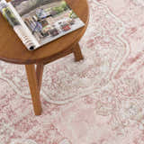 Close-up of the Kandos Blush & Light Pink Area Rug showing its cream, beige, and pink traditional pattern and soft texture. Styleshot