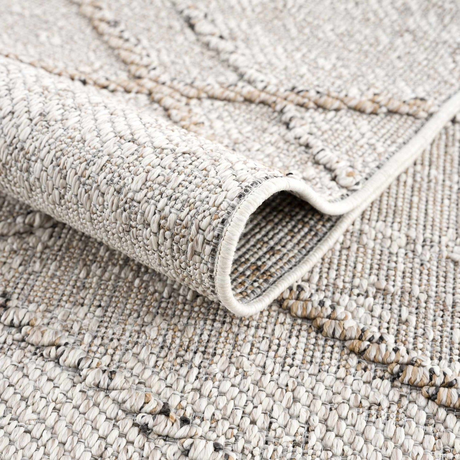 Close-up of the textured Baqer Bone & Tan Performance Rug showing its woven design and neutral color palette. Fold