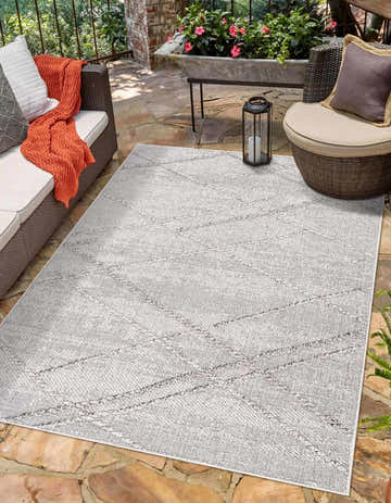 Outdoor patio scene with Baqer Bone & Taupe Textured Performance Rug, wicker furniture, and stone flooring. Roomscene-Rectangle