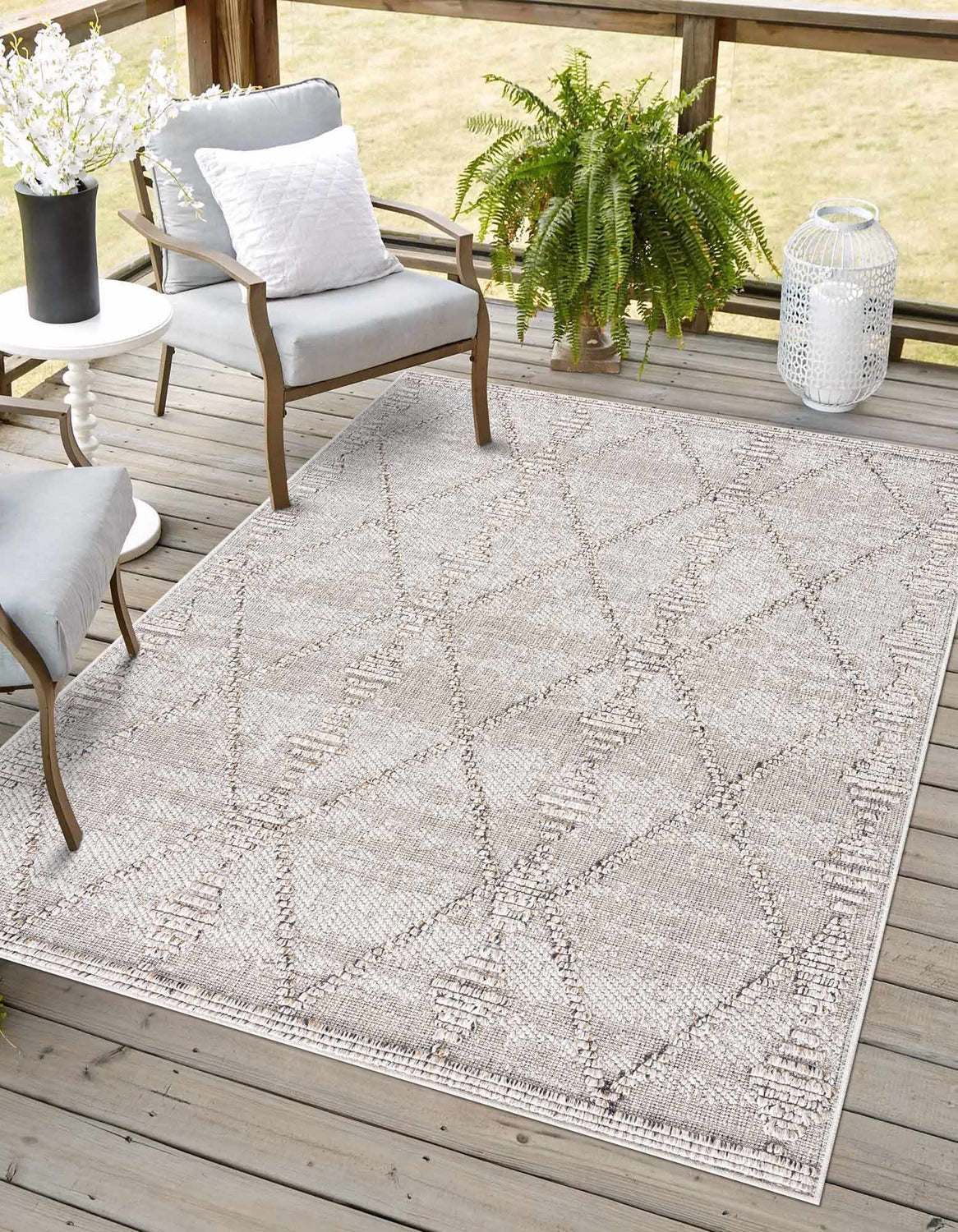 Outdoor patio scene with gray chairs and Nyla Bone Indoor & Outdoor Rug. Contemporary design. Roomscene-Rectangle