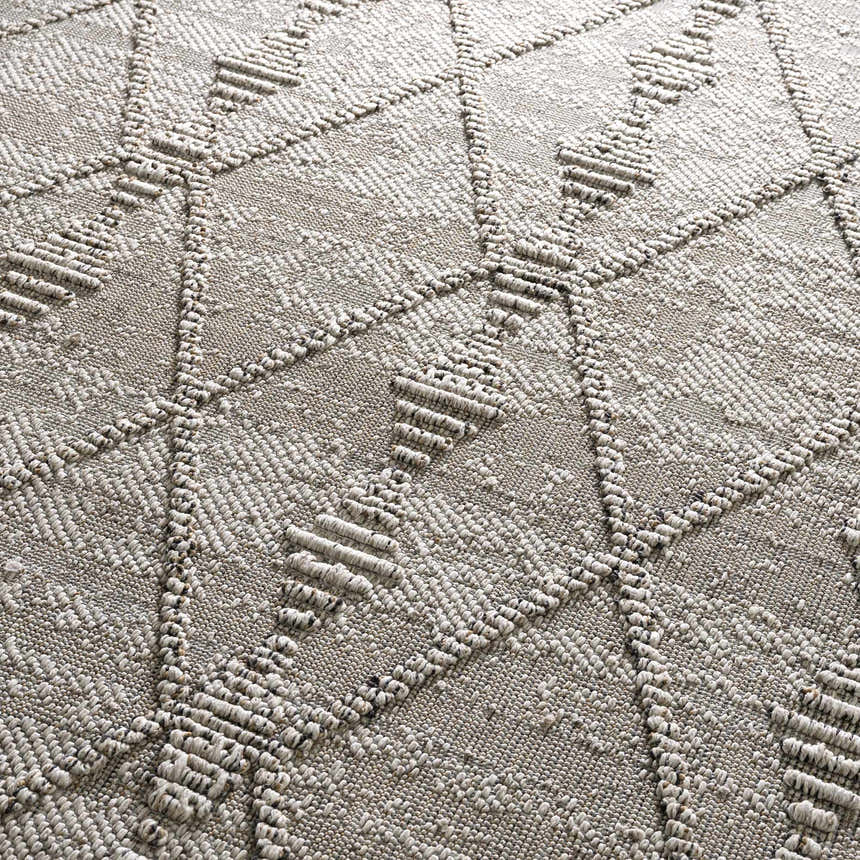 Close-up of the Nyla Bone Indoor Outdoor Rug showing the textured, geometric diamond pattern and bone color. Texture