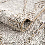 Close-up of the Nyla Bone & Tan Textured Performance Rug showing its woven texture and geometric pattern. Fold