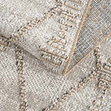 Close-up of the textured Nyla Bone & Tan Performance Rug, showing the woven design and neutral color palette. Fold