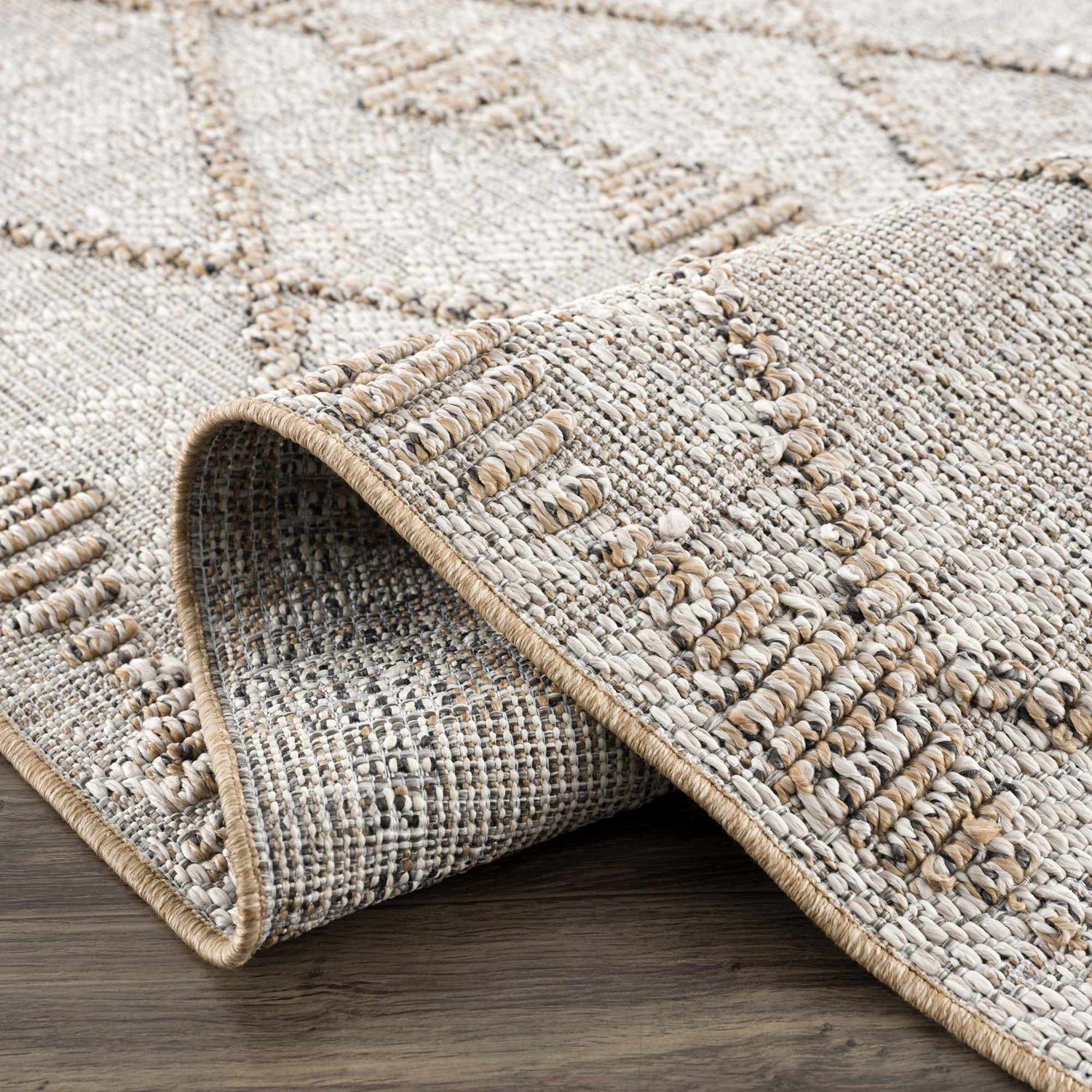 Close-up of Nyla Bone & Tan Textured Performance Rug showing woven texture and geometric pattern. Farmhouse style. Fold
