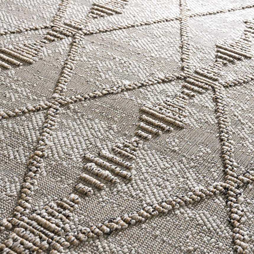Close-up of the Nyla Bone & Tan Textured Performance Rug, featuring a geometric pattern and woven texture. Texture