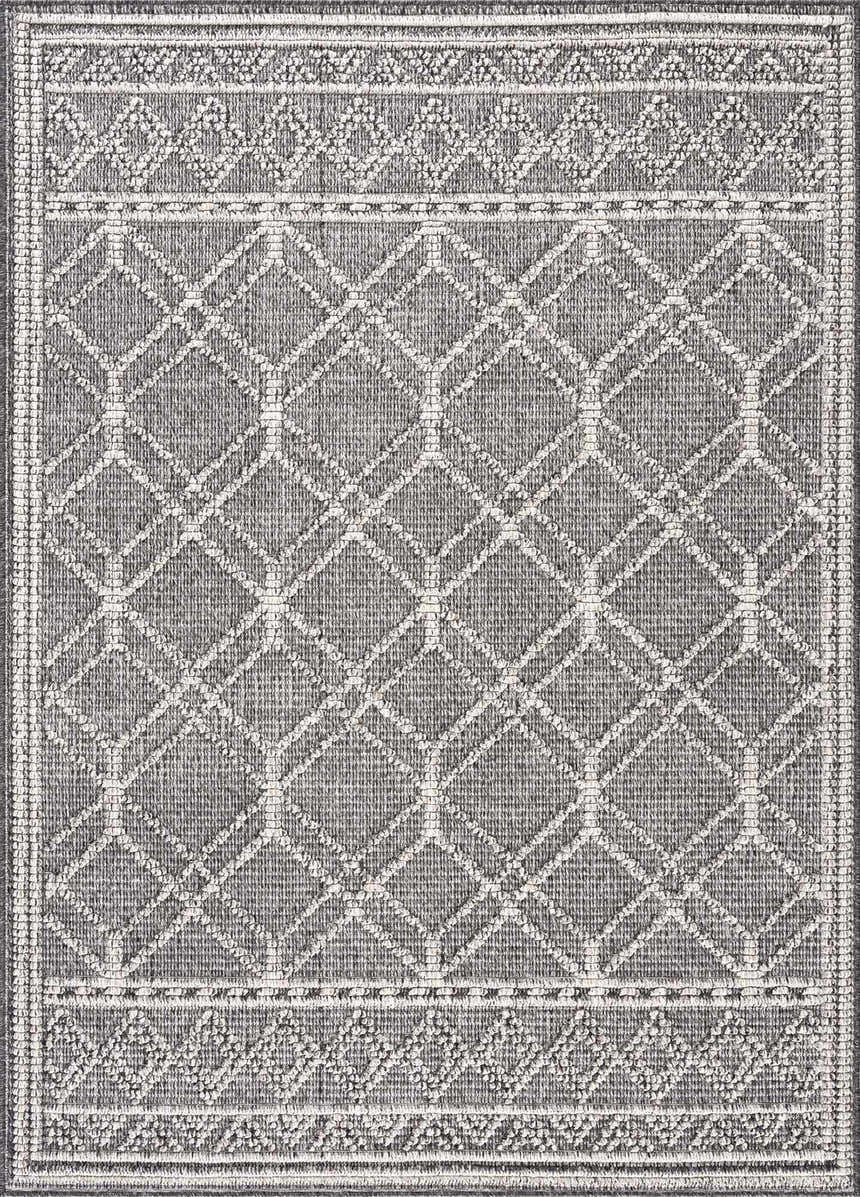Close-up of the Diah Black & Bone Area Rug, featuring a geometric diamond pattern and decorative borders. Design-Rectangle-46