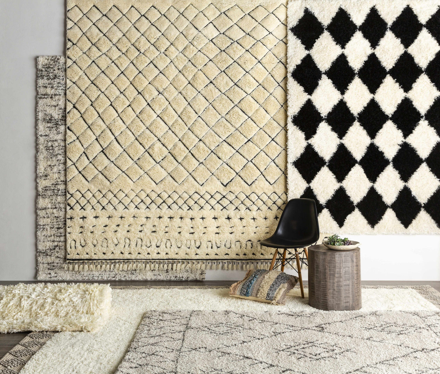 Brundall Clearance Rug display: Cream, black, and gray Moroccan-style wool rugs with geometric patterns and fringe. Styleshot