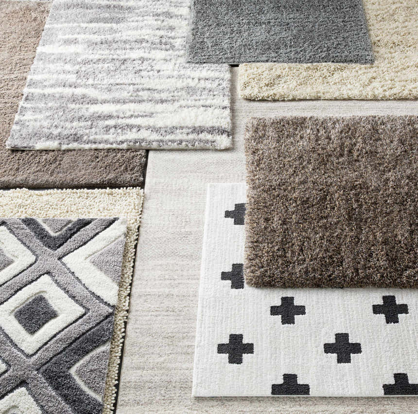 Close-up of various Ascot Area Rugs showcasing textures, patterns, and colors like beige, charcoal, and olive. Styleshot