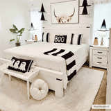 Bedroom scene with a Siari Solid Cream Plush Rug, white furniture, and black and white Halloween decor. Roomscene-Rectangle