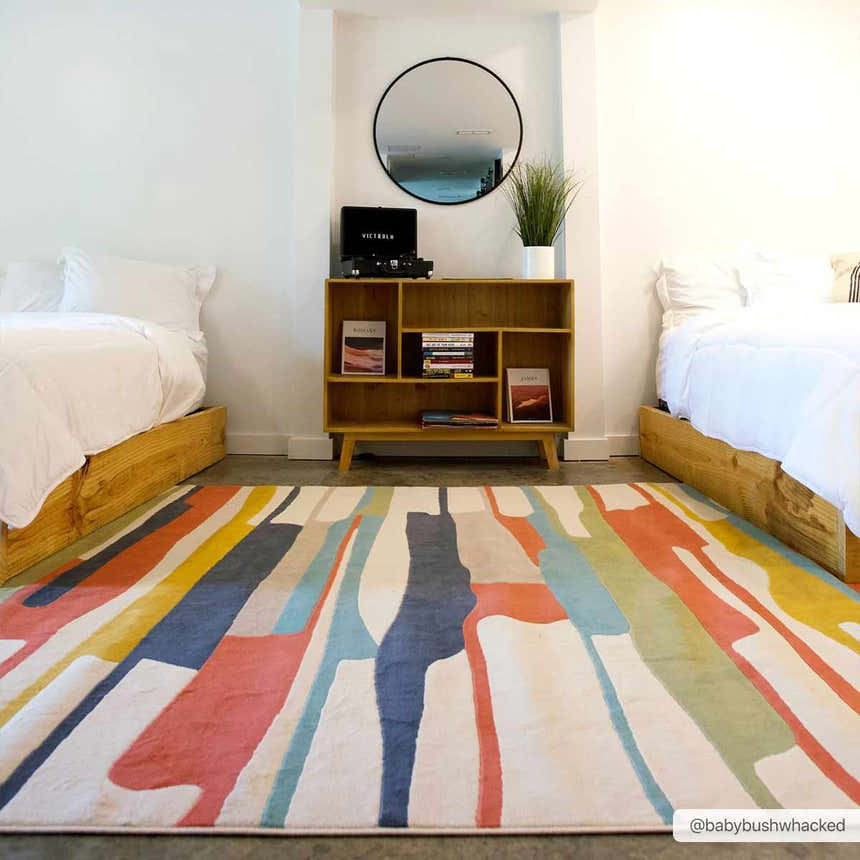 Bedroom scene with two beds and a Southfields Colorful Modern Area Carpet with aqua, orange, and yellow hues. Roomscene-Rectangle