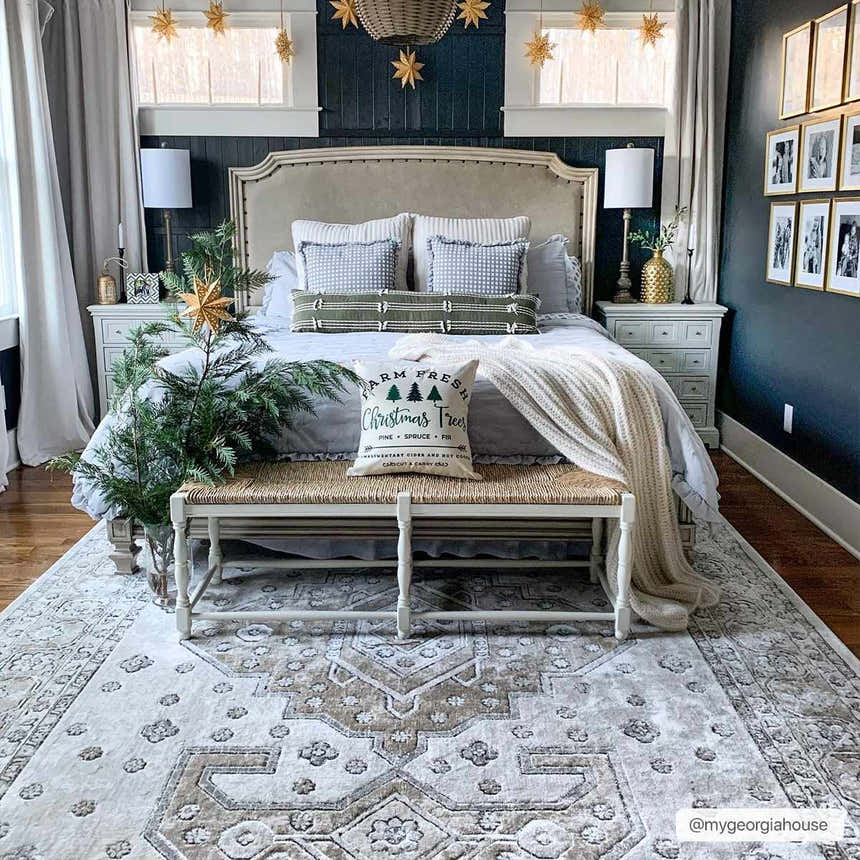 Bedroom scene with beige and charcoal Southwark Area Rug, woven bench, and Christmas decor. Roomscene-Rectangle