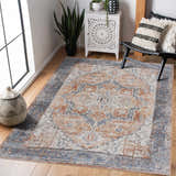 Living room scene with a blue and orange Hera Washable area rug, black chair, and white cabinet. Traditional vintage style. Roomscene-Rectangle