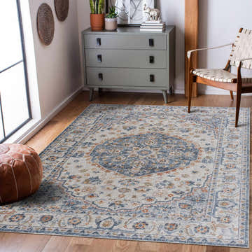 Living room scene with a Hiti Cream&Blue Washable Rug, gray dresser, woven chair, and leather pouf. Oriental, vintage style. Roomscene-Rectangle