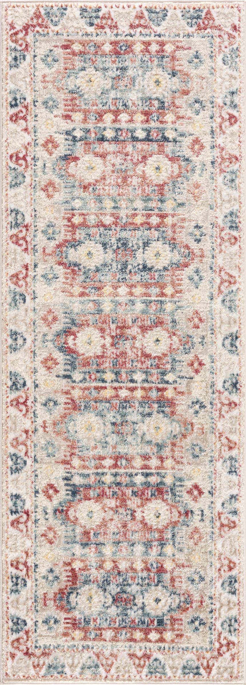 Close-up of Bindi Blue & Rose Area Rug. Southwestern style rug with traditional blue, rose, and ivory tones. Design-Runner