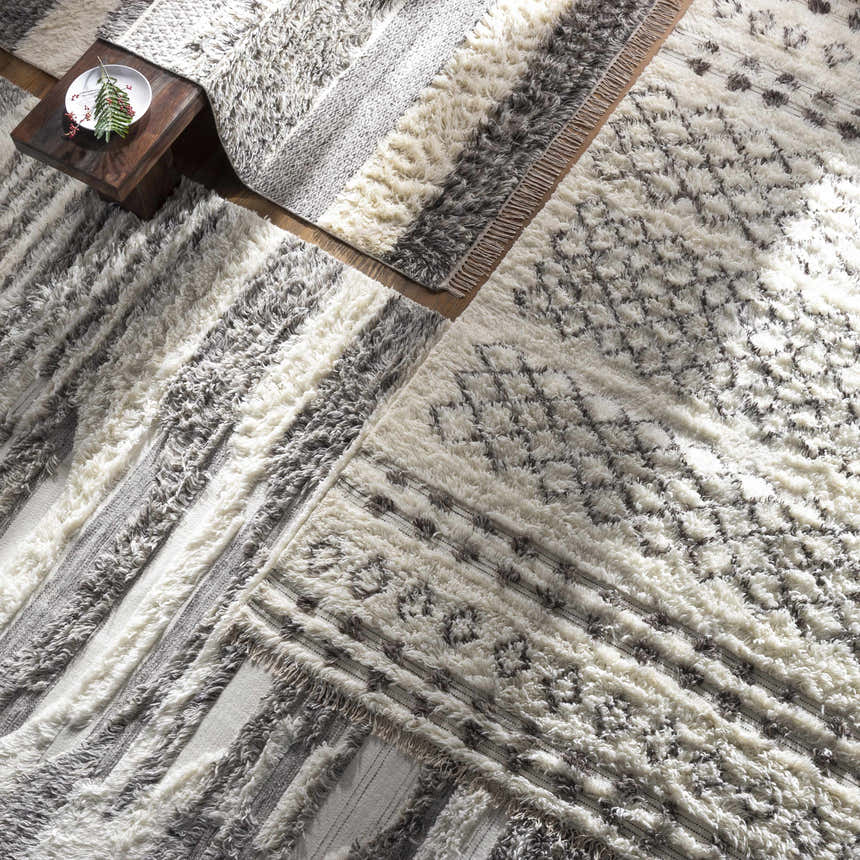 Close-up of the hand-woven Kingsthorpe Area Rug, a cream and dark brown shag rug with Moroccan-inspired patterns and fringe. Styleshot