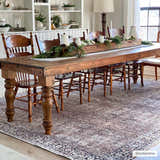 Farmhouse dining room with wood table and chairs on Jill Washable Area Rug in brown, blue, and cream. Roomscene-Rectangle