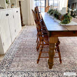 Farmhouse dining room with a brown wood table and Jill Washable Area Rug in brown, blue, and black. Roomscene-Rectangle