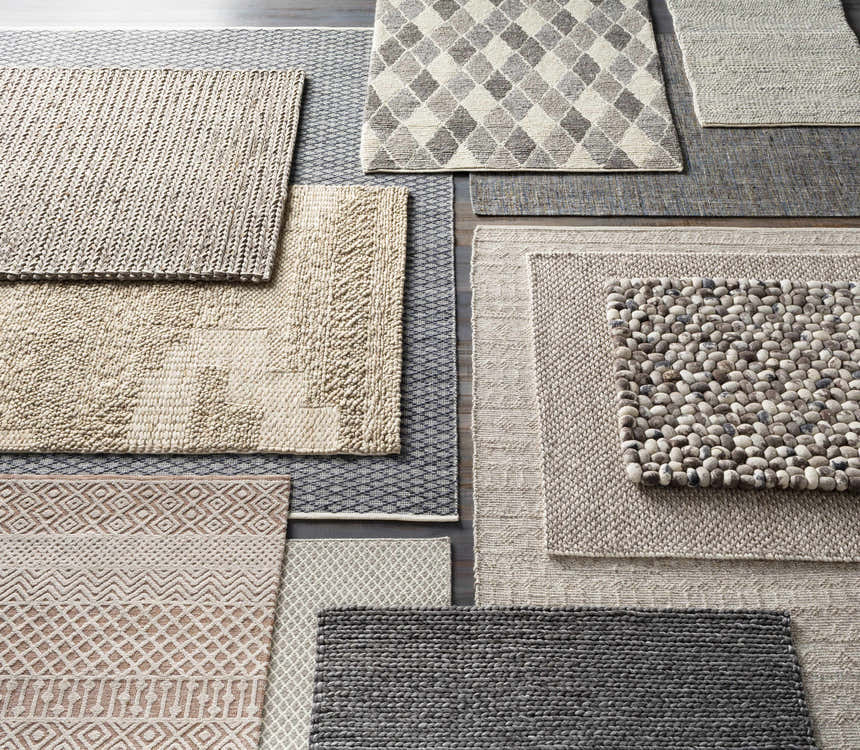 Various textures and patterns of Keldron Clearance Rugs in charcoal, cream, and brown tones. Contemporary style. Texture