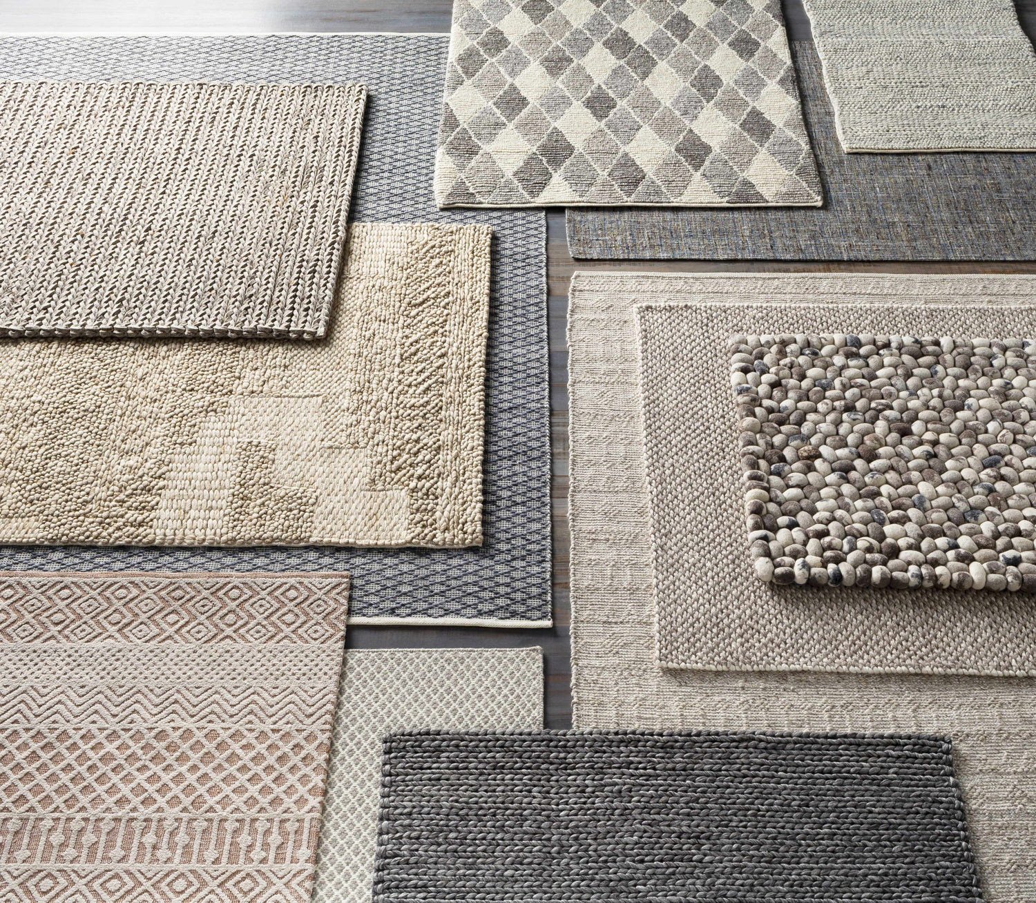 Various textures and patterns of Keldron Clearance Rugs in charcoal, cream, and brown tones. Contemporary style. Texture