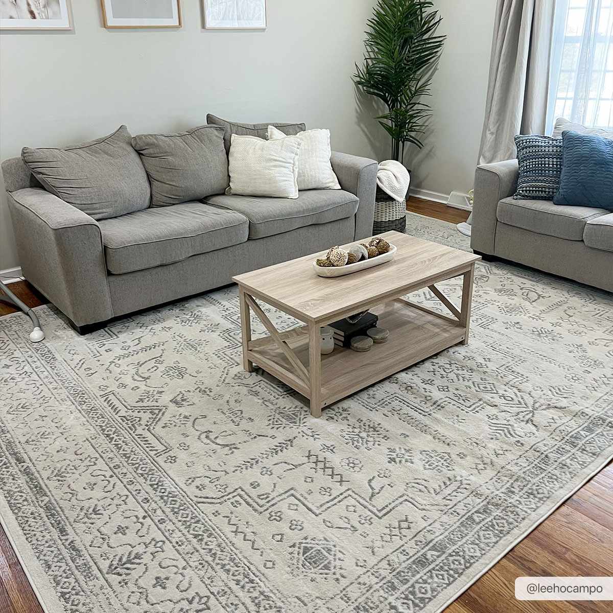 Living room scene with gray sofas and Tigried Ivory & Gray 2323 Area Rug. The rug has a traditional, bohemian pattern. Roomscene-Rectangle