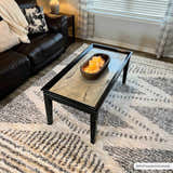 Living room scene with a Trunding Plush Area Rug in charcoal and cream under a black coffee table. Roomscene-Rectangle