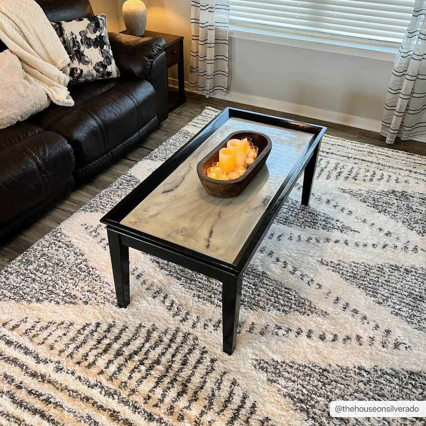 Living room scene with a Trunding Plush Area Rug in charcoal and cream under a black coffee table. Roomscene-Rectangle