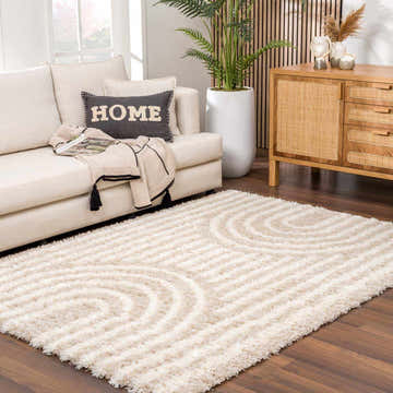 Living room scene with a white sofa and the Emmly Shag Area Rug in white thatch with a geometric design. Roomscene-Rectangle