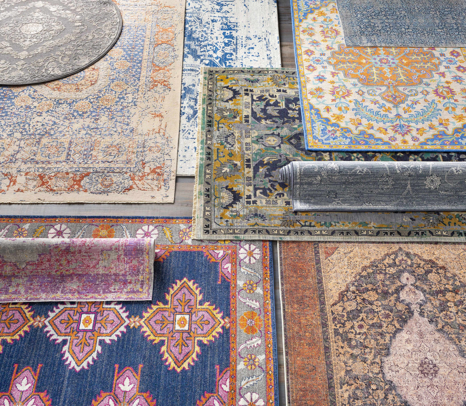 Overhead shot of various rug styles and colors, including the Yorkana Distressed Blue Rug. Styleshot