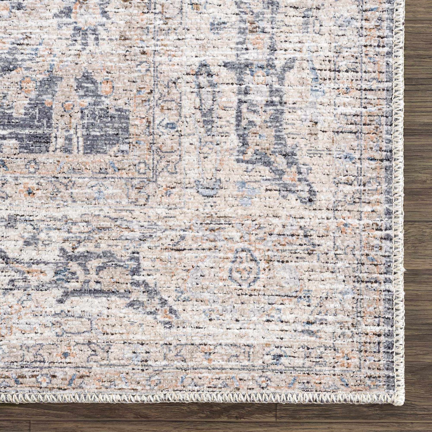 Close-up of Kayin Washable Rug, showcasing its silver, gray, and beige traditional pattern and soft chenille-polyester texture. Swatch