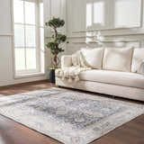 Living room scene with a silver and gray Kayin Washable Rug, cream sofa, wood floors, and natural light. Roomscene-Rectangle