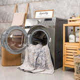 Laundry room scene with silver washing machine and silver and gray Kayin Washable Rug partially inside. Washing-Machine