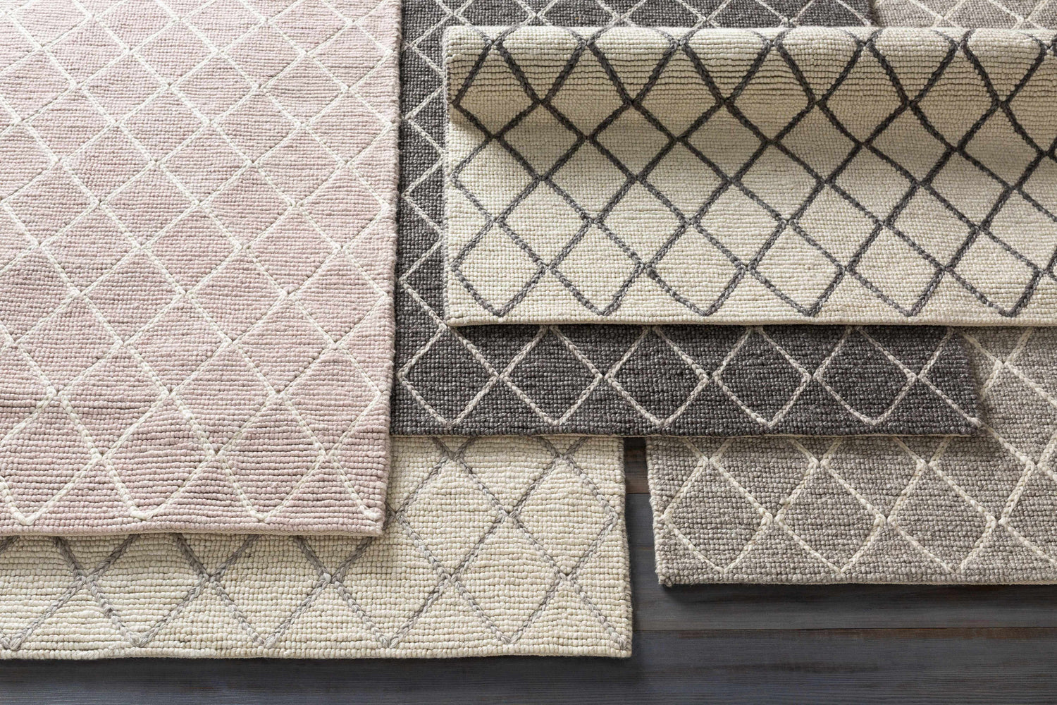 Close-up of Kanopolis Carpet in black, cream, medium gray. Hand woven wool and viscose rug with a contemporary diamond pattern. Styleshot