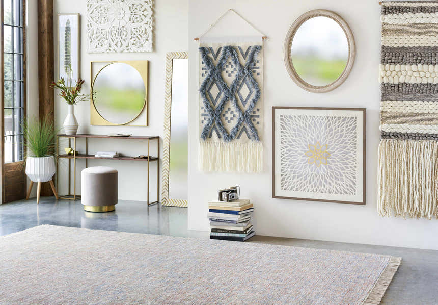 Styled room scene with Atulayan Premium Rug in light gray, blue, and coral. Bohemian decor, console table, and modern accents. Styleshot
