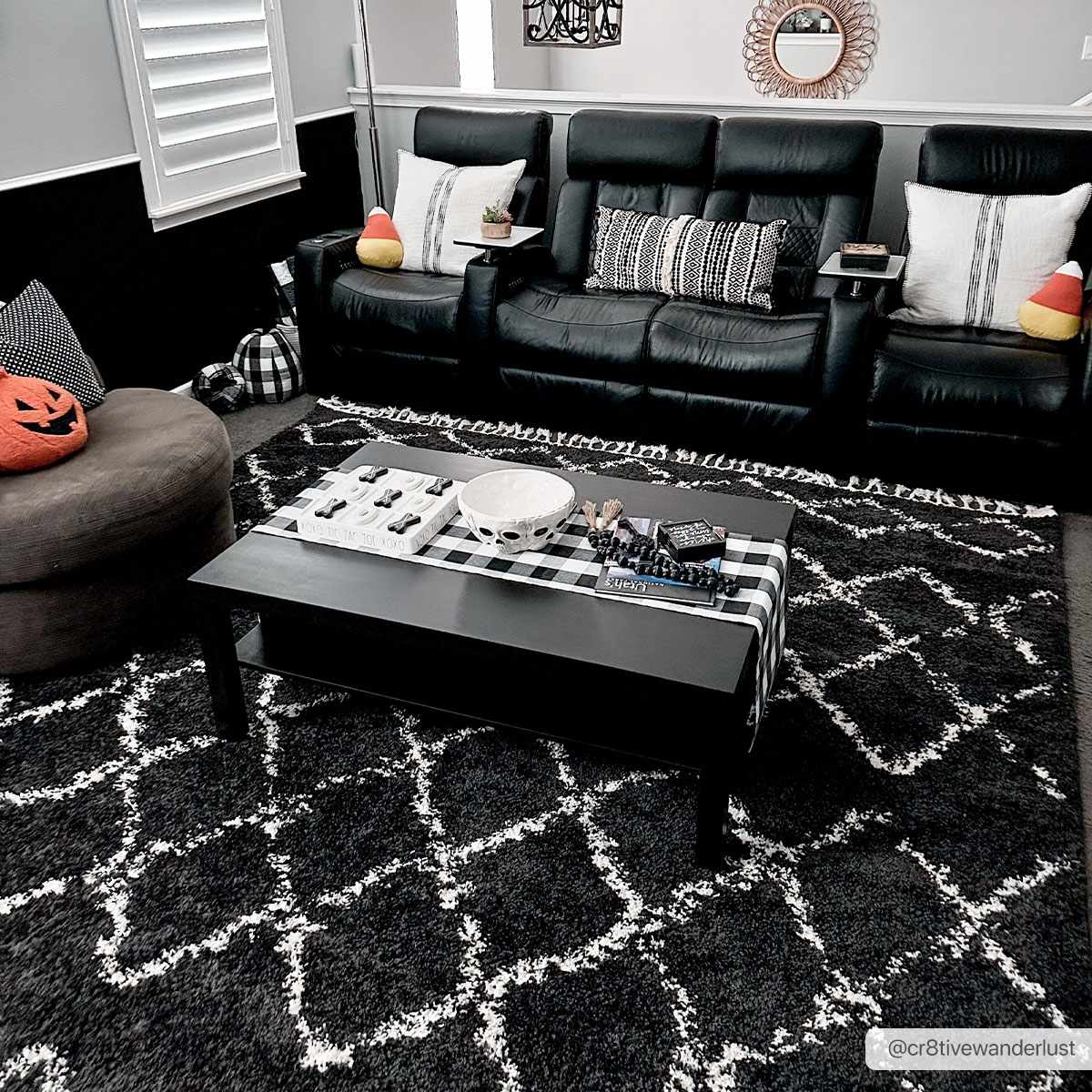 Living room scene with a Wallagrass Black Moroccan Shag Rug, black leather sofa, and Halloween decor. Roomscene-Rectangle