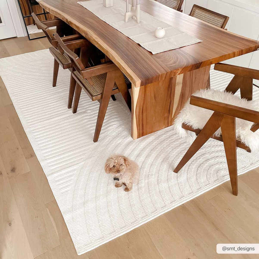 Dining room with wood table and Deron White Washable 3D Rug. A cute dog sits on the rug. Roomscene-Rectangle