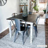 Farmhouse dining room with a black table and the cream and black Williford Wool Area Rug. Roomscene-Rectangle