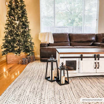 Living room scene with Christmas tree and cream, black Williford Wool Area Rug. Farmhouse style with brown leather couch. Roomscene-Rectangle