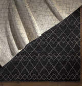 Close-up of the Mozon Handmade Faux Silk Area Rug showing its gray and light gray diamond pattern and wool texture. Styleshot