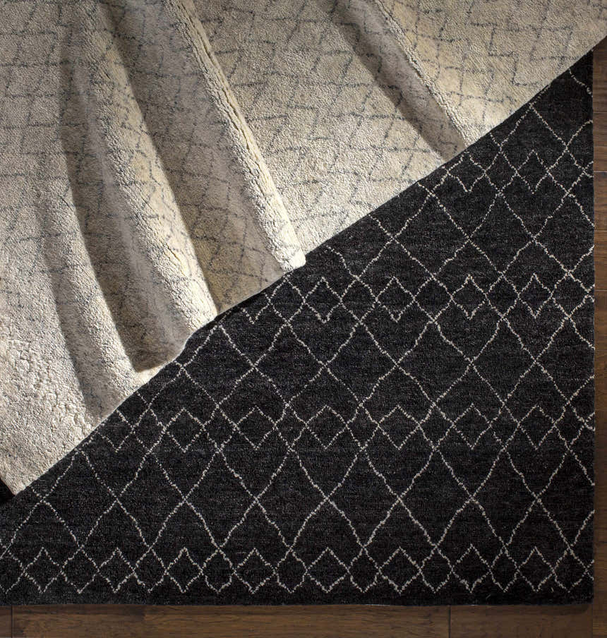 Close-up of the Mozon Handmade Faux Silk Area Rug showing its gray and light gray diamond pattern and wool texture. Styleshot