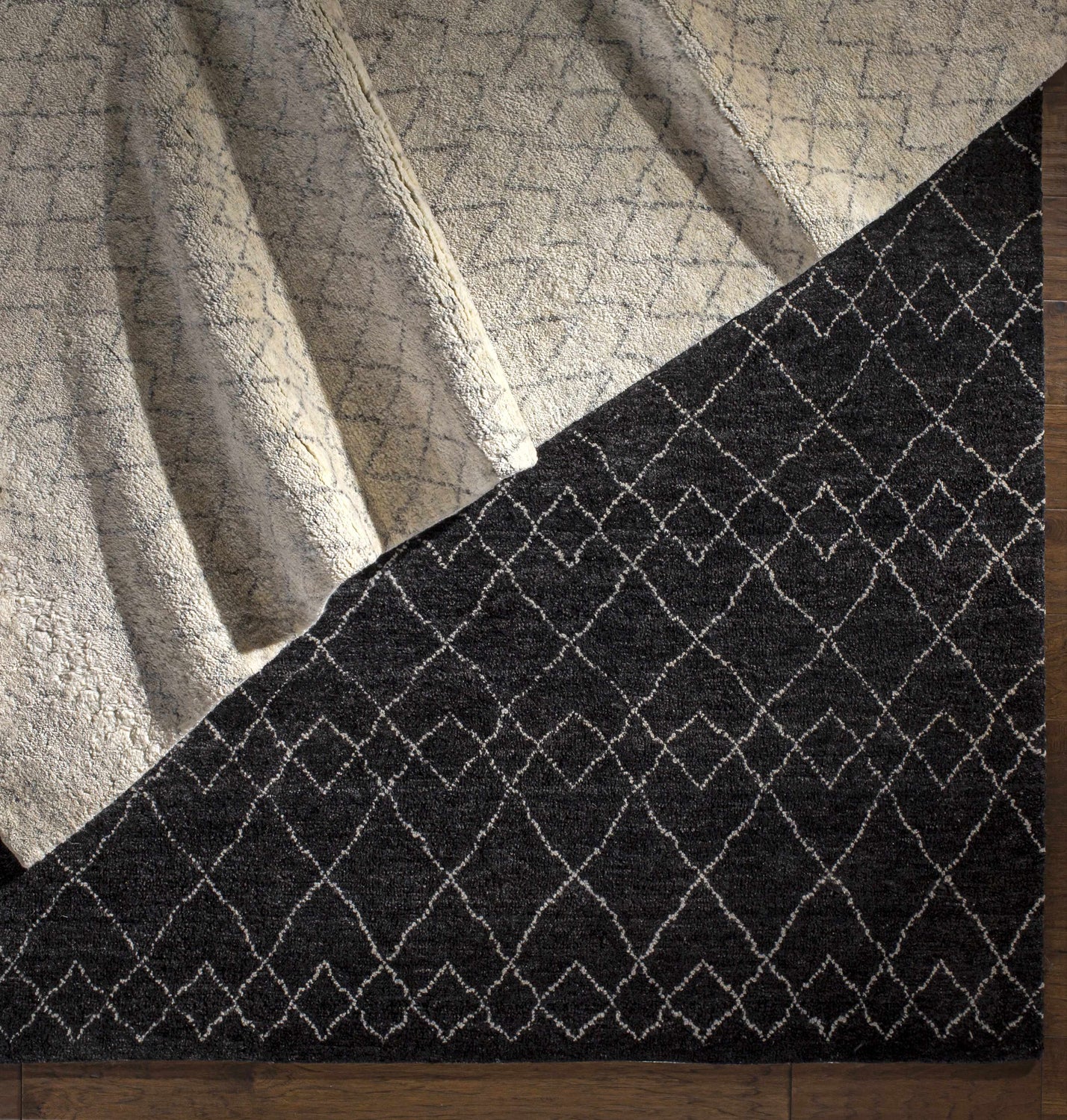 Close-up of the Mozon Handmade Faux Silk Area Rug showing its gray and light gray diamond pattern and wool texture. Styleshot