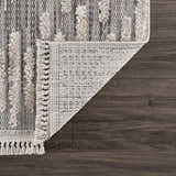 Close-up of the Poydras High-Low Rustic Rug showing charcoal, gray, and light beige tones and high-low pile texture. Fold