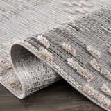 Close-up of the Poydras High-Low Rustic Rug. Charcoal and gray rug with a textured, high-low design. Fold