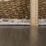 Close-up of the light beige Poydras High-Low Rustic Rug showing texture and pile height with a ruler. Pile