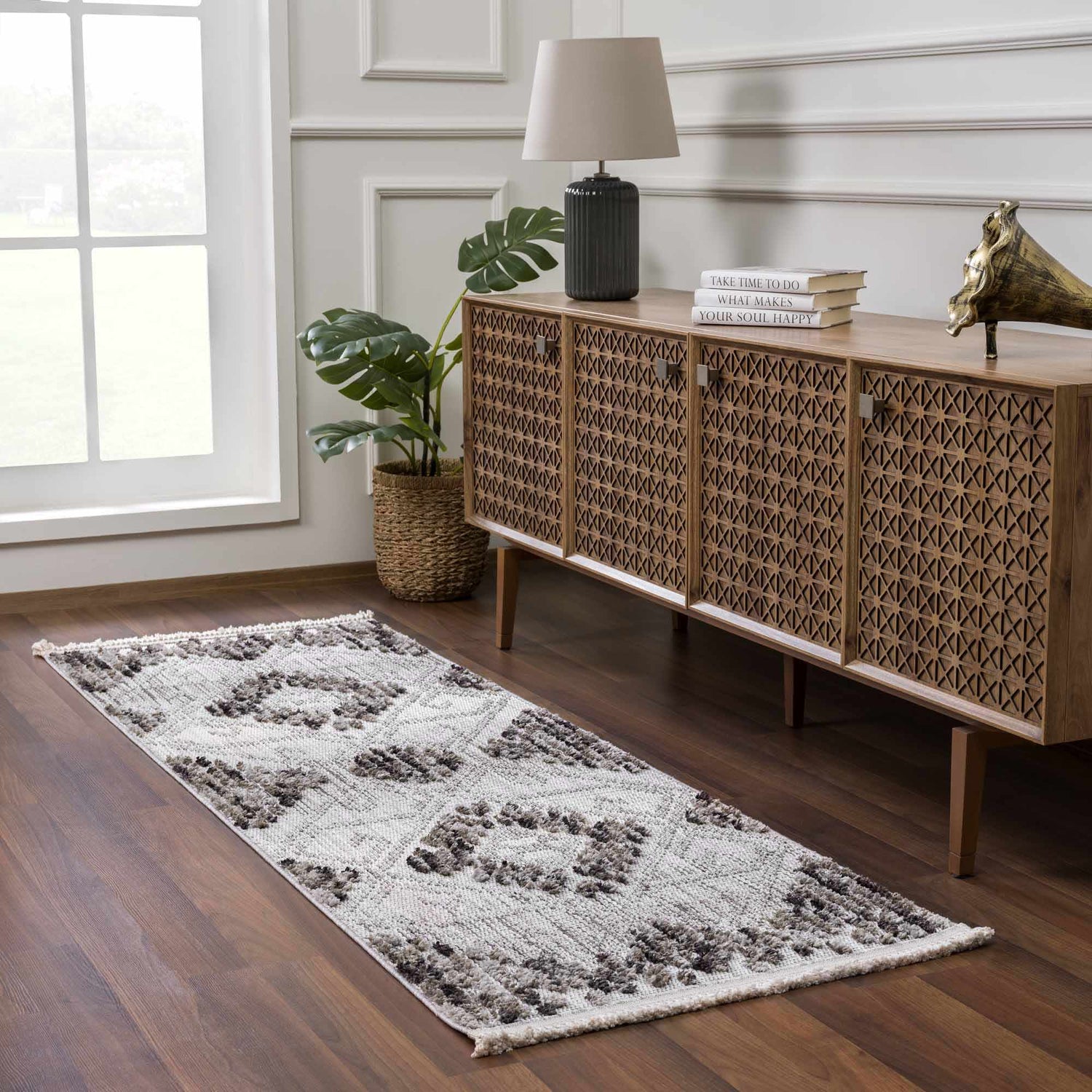 Entryway with a charcoal and cream Cabarroguis Area Rug runner, wood floors, and patterned wood cabinet. Roomscene-Runner