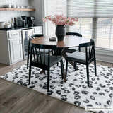 Dining room with round table and Zhen Black Spots Leopard Rug. Modern black and white decor. Roomscene-Rectangle