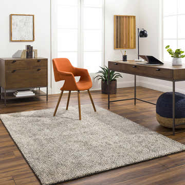 Contemporary home office with wood desk, orange chair, and beige Abiba Area Rug. Roomscene-Rectangle