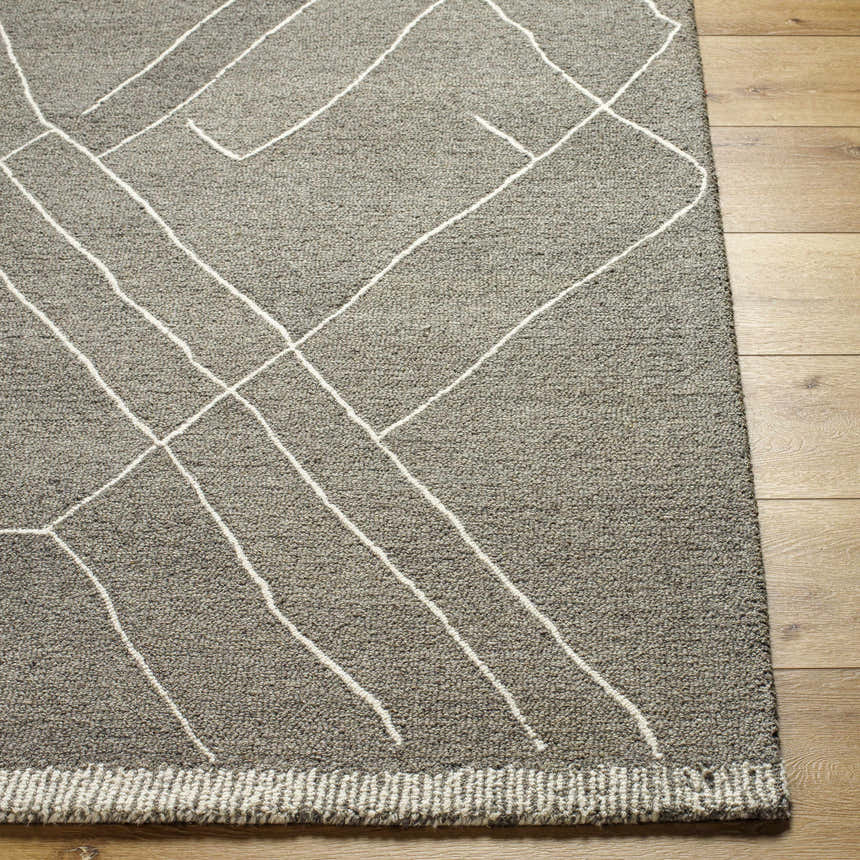 Close-up of Arsenal Trout Valley Gray Wool Rug. Hand-tufted rug with driftwood color and white geometric line pattern. Front